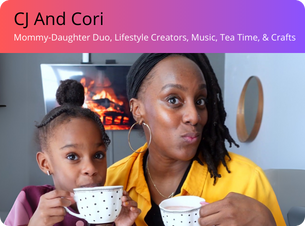 Two people, one adult and one child, holding tea cups with a fireplace in the background.