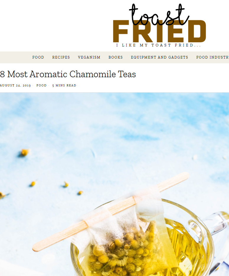 Tea bag in a glass of tea with chamomile flowers on a light blue background, featuring the 'toast FRIED' logo.